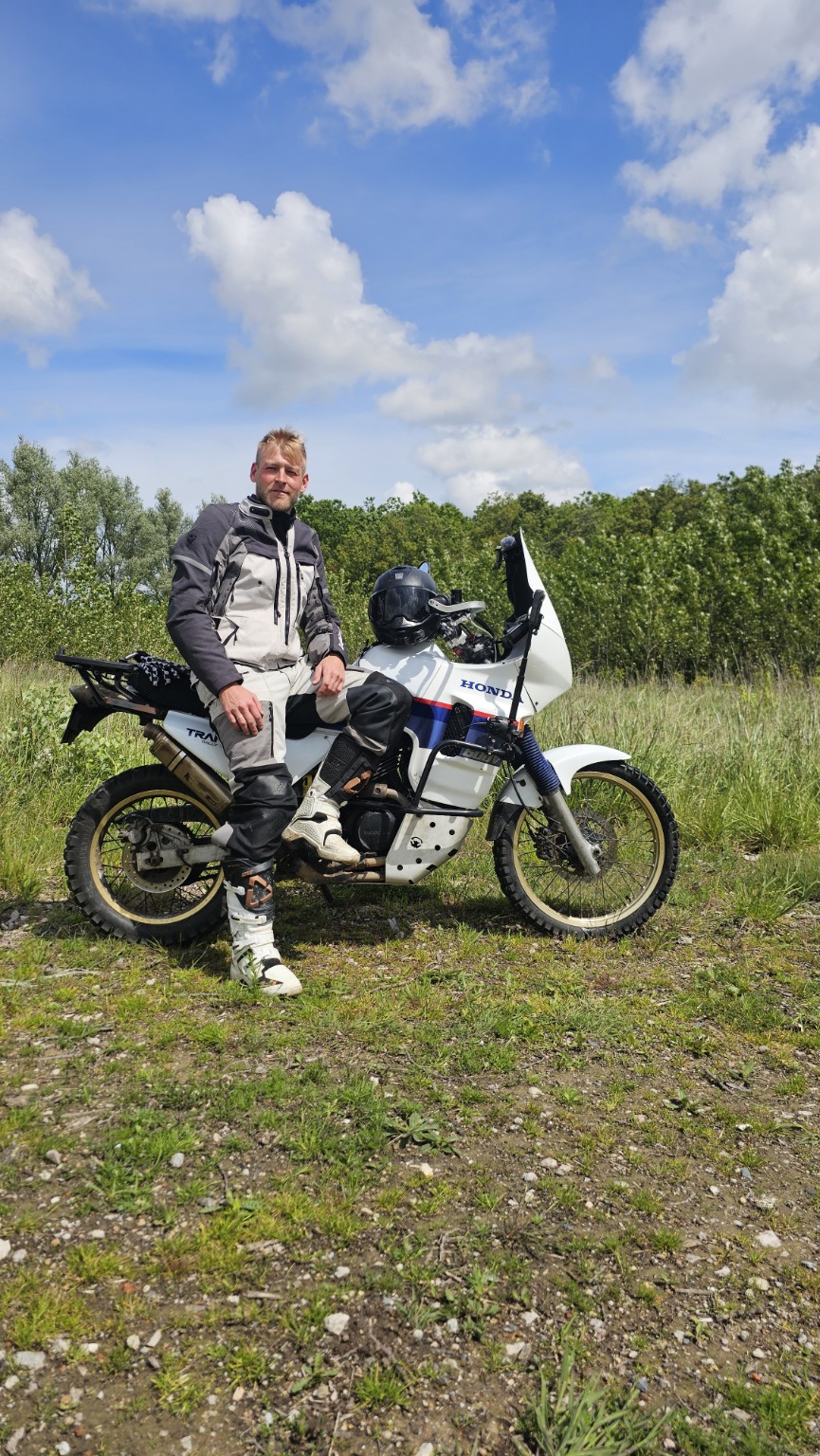 Henk sitting on his Honda Transalp during an off-road ride